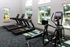 Modern fitness center with state-of-the-art equipment and scenic pool views.