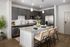 Modern kitchen with sleek gray cabinets, stainless steel appliances, and a stylish breakfast bar featuring elegant pendant lighting.