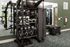 Modern fitness room showcasing a versatile exercise station with kettlebells, medicine balls, and resistance bands against a stylish mirrored wall.