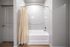 Modern bathroom with elegant tiling featuring a sleek bathtub and warm accent lighting.