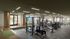 Modern fitness center with state-of-the-art gym equipment, bright natural lighting, and spacious workout area overlooking scenic views.