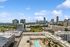 Breathtaking urban skyline view featuring modern high-rise buildings and a luxurious rooftop pool.