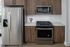 Sleek modern kitchen featuring stainless steel appliances, elegant wood cabinetry, and a charming floral arrangement.