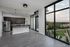 Chic modern kitchen with sleek cabinets, stainless steel appliances, and expansive windows offering stunning cityscape views.