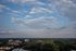 Breathtaking aerial view showcasing vibrant greenery, a serene skyline, and scattered office buildings under a picturesque sky.