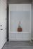 Chic entryway with white built-in storage and elegant hooks, featuring a stylish brown handbag, perfect for modern organization.