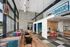 Modern and inviting coworking space featuring stylish seating areas, large windows, and contemporary decor accents.
