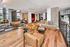Modern open-concept lounge with comfortable seating, stylish decor, and large windows for natural light.