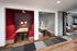 Chic modern apartment interior featuring two cozy built-in dining booths with stylish lighting, set against a vibrant and contemporary decor.
