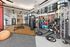 Modern fitness facility featuring state-of-the-art gym equipment, vibrant exercise balls, and sleek wooden flooring.
