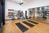 Modern fitness studio with yoga mats, colorful exercise balls, and mirrored walls for a complete workout experience.