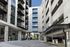 Modern urban apartment complex with sleek architecture, featuring spacious balconies and stylish exterior design.