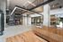 Modern apartment lobby featuring a sleek spiral staircase, high ceilings, and stylish wooden reception desk.