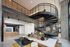 Modern apartment lobby with a striking spiral staircase, chic seating area, and stylish contemporary design.