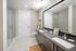 Contemporary bathroom with dual sinks, sleek glass shower, and modern fixtures in a spacious layout.