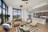 Sleek open-concept apartment living room featuring modern decor, a spacious kitchen with a bar counter, and expansive floor-to-ceiling windows offering stunning views.