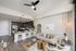 Chic modern apartment with open-plan kitchen, stylish living area, and elegant decor featuring natural wood accents and cozy lighting.