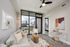 Modern apartment living area with city skyline view, cozy gray sofa, chic lighting, and stylish decor.