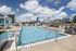 Luxurious rooftop swimming pool with city skyline views, surrounded by stylish lounges and cabanas, perfect for relaxation and leisure.