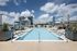 Luxurious rooftop pool with stylish lounge spaces and stunning city skyline views.