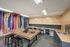 Vibrant and modern creative workspace with colorful abstract wall art, wooden countertops, and toolkit on the table.