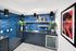 Contemporary wet bar featuring vibrant blue subway tiles, sleek cabinetry, and stylish decor accents for a chic atmosphere.