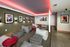 Chic entertainment lounge with modern seating, vibrant wall art, and ambient lighting.