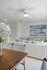 Bright and modern living room with cozy seating, elegant artwork, and a chic dining area showcasing contemporary style.