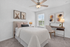 Charming bedroom with modern decor featuring cozy bed, elegant desk, and stylish artwork. Bright and inviting ambiance.