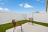 Charming outdoor patio with modern wicker chairs, perfect for relaxation and enjoying the open sky.