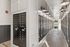 Modern apartment mailroom with sleek black mailboxes and warm lighting, offering convenient and secure mail access.