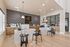 Elegant leasing office with modern decor at Rovena at Mt. Zion, featuring stylish pendant lighting and a welcoming reception area.