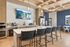 Chic modern kitchen with stylish bar seating, elegant wood cabinetry, and a cozy breakfast nook.