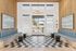 Chic apartment lobby with modern checkered flooring, elegant light fixture, and stylish seating area.