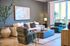 Chic modern living room with stylish decor, plush seating, and abundant natural light from large windows.