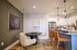 Modern apartment kitchen and dining area with elegant lighting, sleek countertops, and cozy seating spaces.