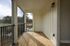Inviting screened porch with elegant wooden flooring and scenic outdoor views, perfect for relaxation and entertainment.