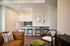 Modern open-concept living space with stylish decor, featuring a sleek kitchen, cozy seating area, and contemporary accents.