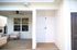 Chic outdoor space with cozy seating area, ceiling fan, and modern tiled outdoor shower.