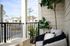 Charming balcony with cozy seating and lush greenery, perfect for relaxation and enjoying serene views.