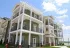 Exterior of luxurious apartments, highlighting wrap-around patios and balconies.