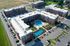 Aerial view of modern apartment complex featuring a lush courtyard with a swimming pool and tennis court, surrounded by ample parking and scenic green spaces.