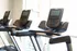 Modern fitness center featuring state-of-the-art treadmills with large screens, abundant natural light, and a sleek design.