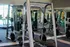 Modern fitness center featuring state-of-the-art equipment, including weightlifting machines and mirrored walls for an enhanced workout experience.