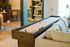 Chic living space featuring a shuffleboard table, comfortable sofa, and modern decor, perfect for relaxation and entertainment.