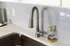 Modern kitchen design featuring a sleek stainless steel faucet and stylish gray backsplash.