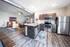 Modern open-plan apartment featuring a spacious kitchen with stainless steel appliances, cozy living area, and stylish decor.
