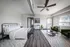 Chic studio apartm arent with modern decor, featuring a cozy bed, stylish greenmchairs, and ample natural light.