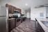 Modern kitchen with sleek stainless steel appliances, dark wood cabinets, and elegant granite countertops, offering a contemporary and inviting atmosphere.
