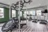 Bright, modern gym featuring state-of-the-art equipment, including treadmills and exercise machines, with abundant natural light and spacious layout.